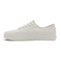 Side view of UNFORMED white canvas low-top sneakers