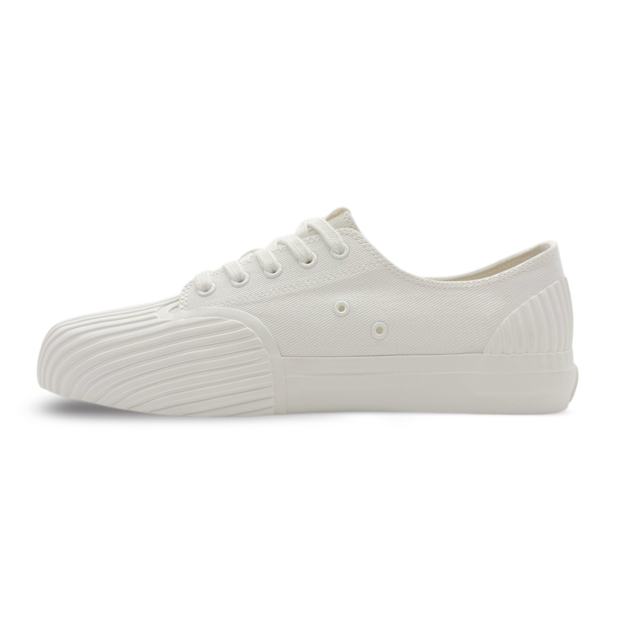 Side view of UNFORMED white canvas low-top sneakers