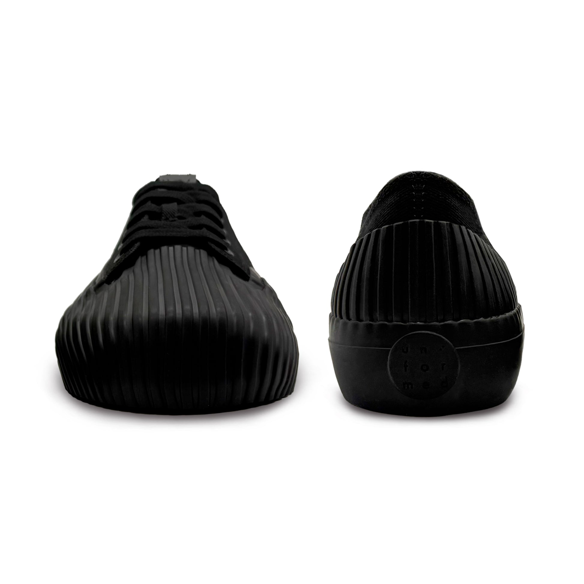 Front and back view of UNFORMED black canvas low-top sneakers