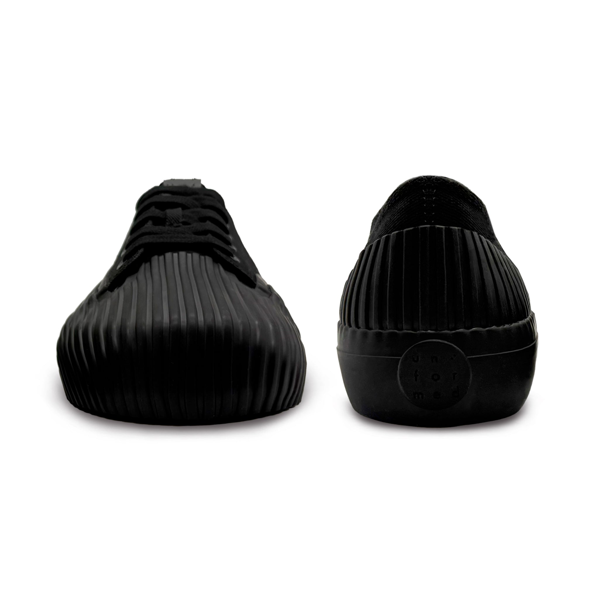 Front and back view of UNFORMED black canvas low-top sneakers