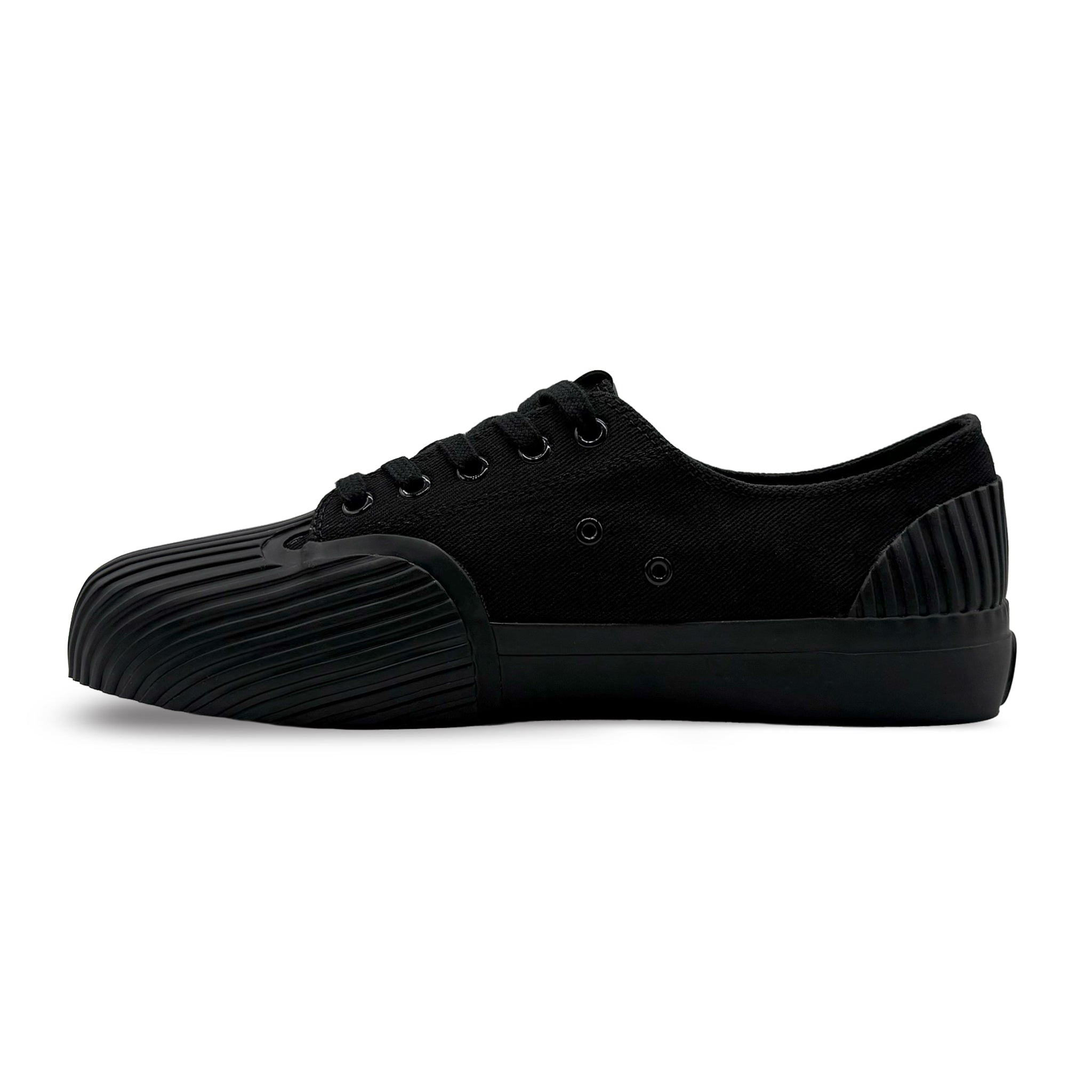 Side view of UNFORMED black canvas low-top sneakers