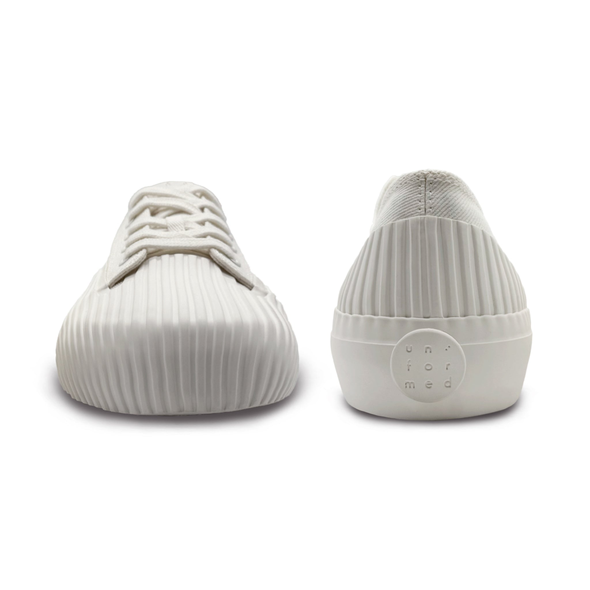 Front and back view of UNFORMED white canvas low-top sneakers