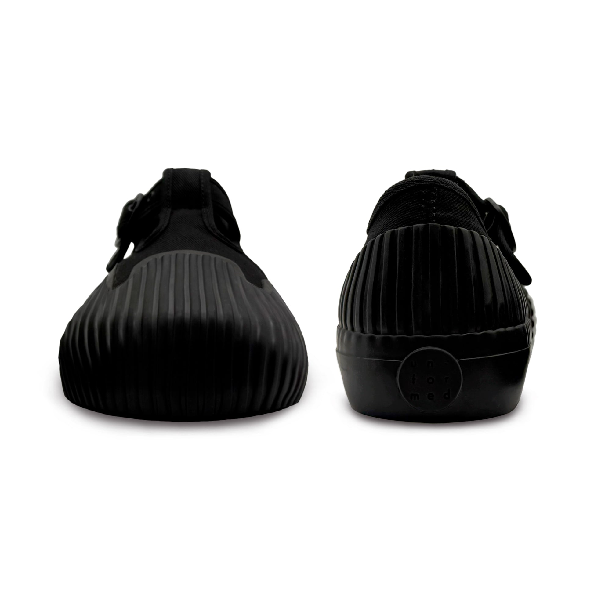 Front and back view of UNFORMED black canvas low-top sneakers