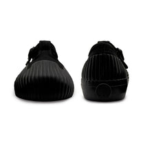 Front and back view of UNFORMED black canvas low-top sneakers