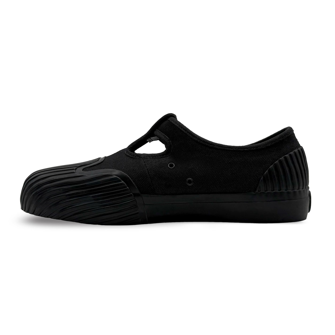 Side view of UNFORMED black canvas low-top sneakers