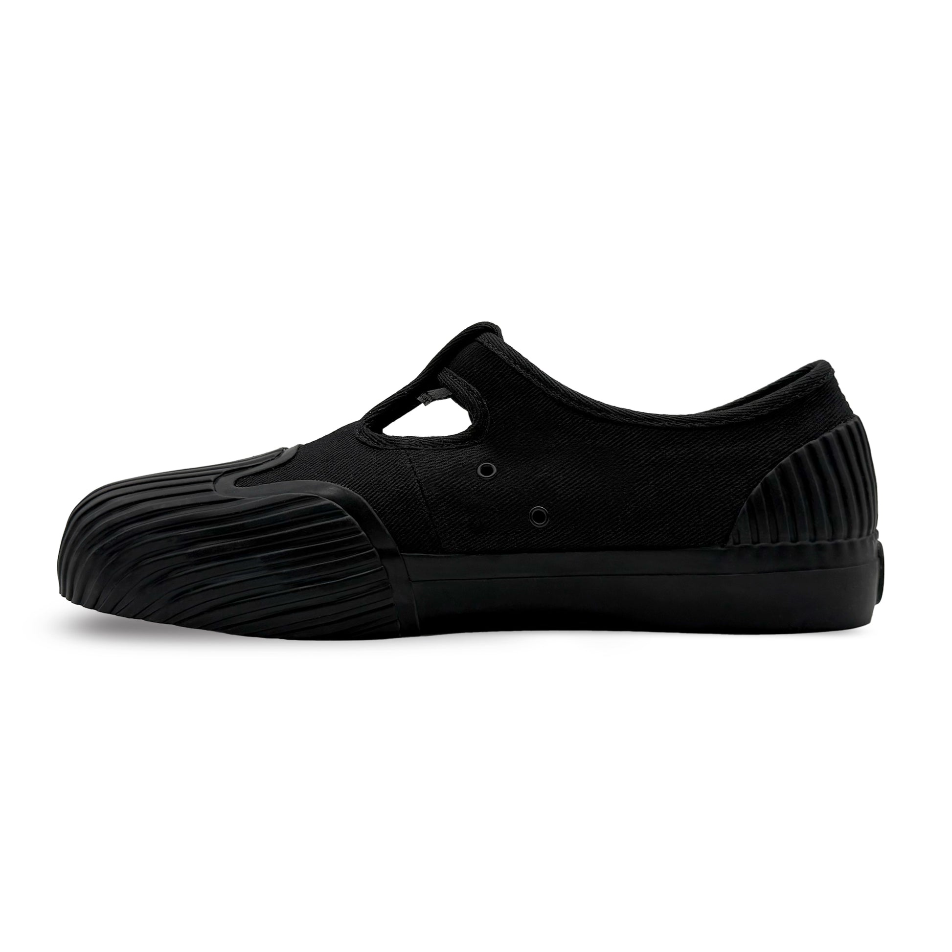 Side view of UNFORMED black canvas low-top sneakers