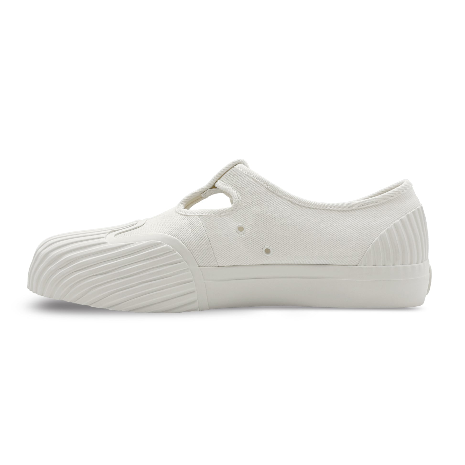 Side view of UNFORMED white canvas T-strap sneakers
