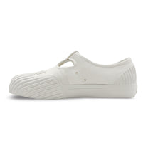 Side view of UNFORMED white canvas T-strap sneakers